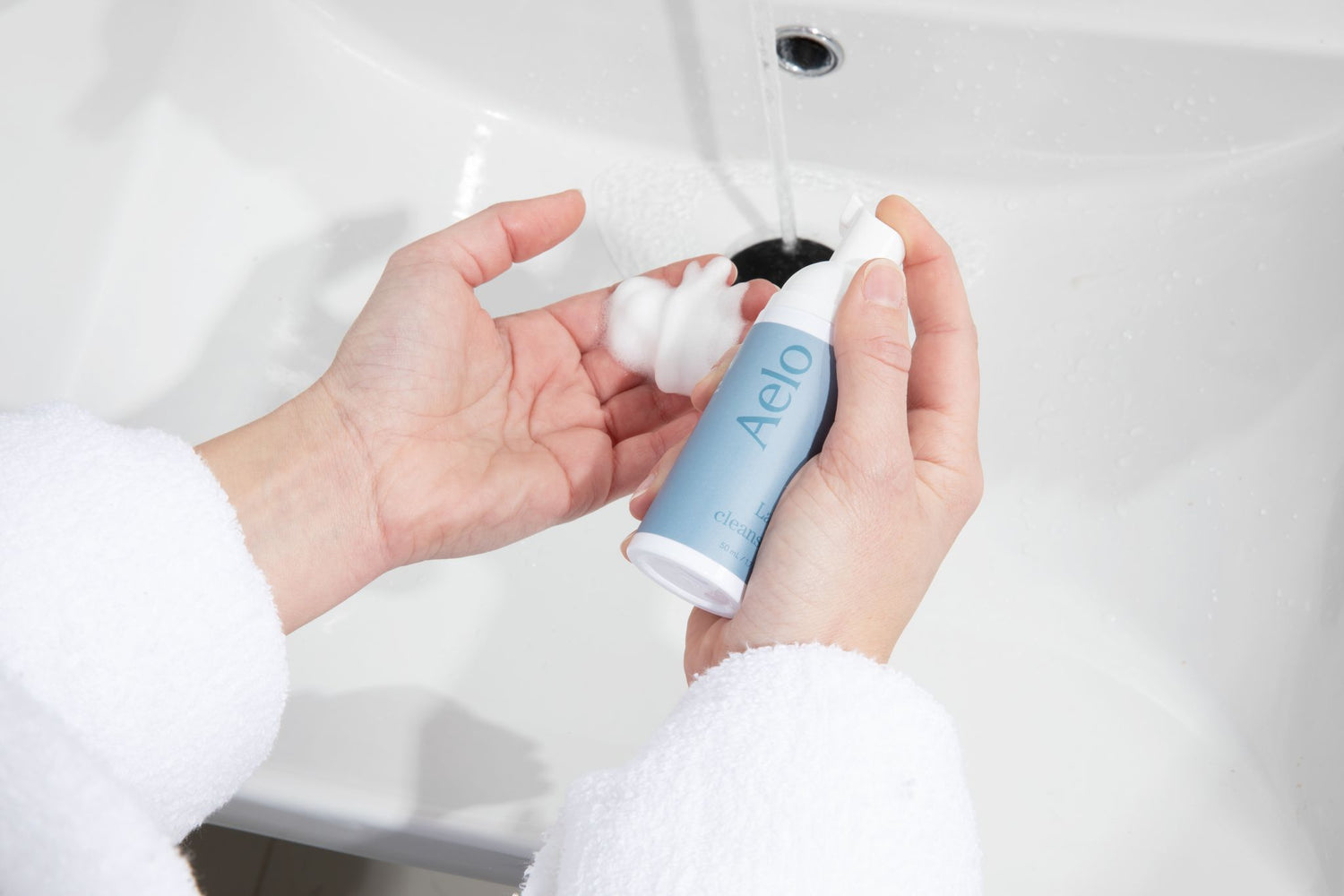 Aelo Eyelid and Eyelash Cleanser Being Used In The Bathroom Sink