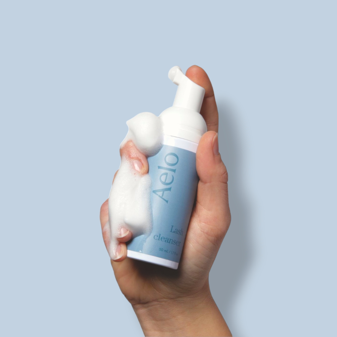 Aelo Eyelid and Eyelash Cleanser Held By Model Hand