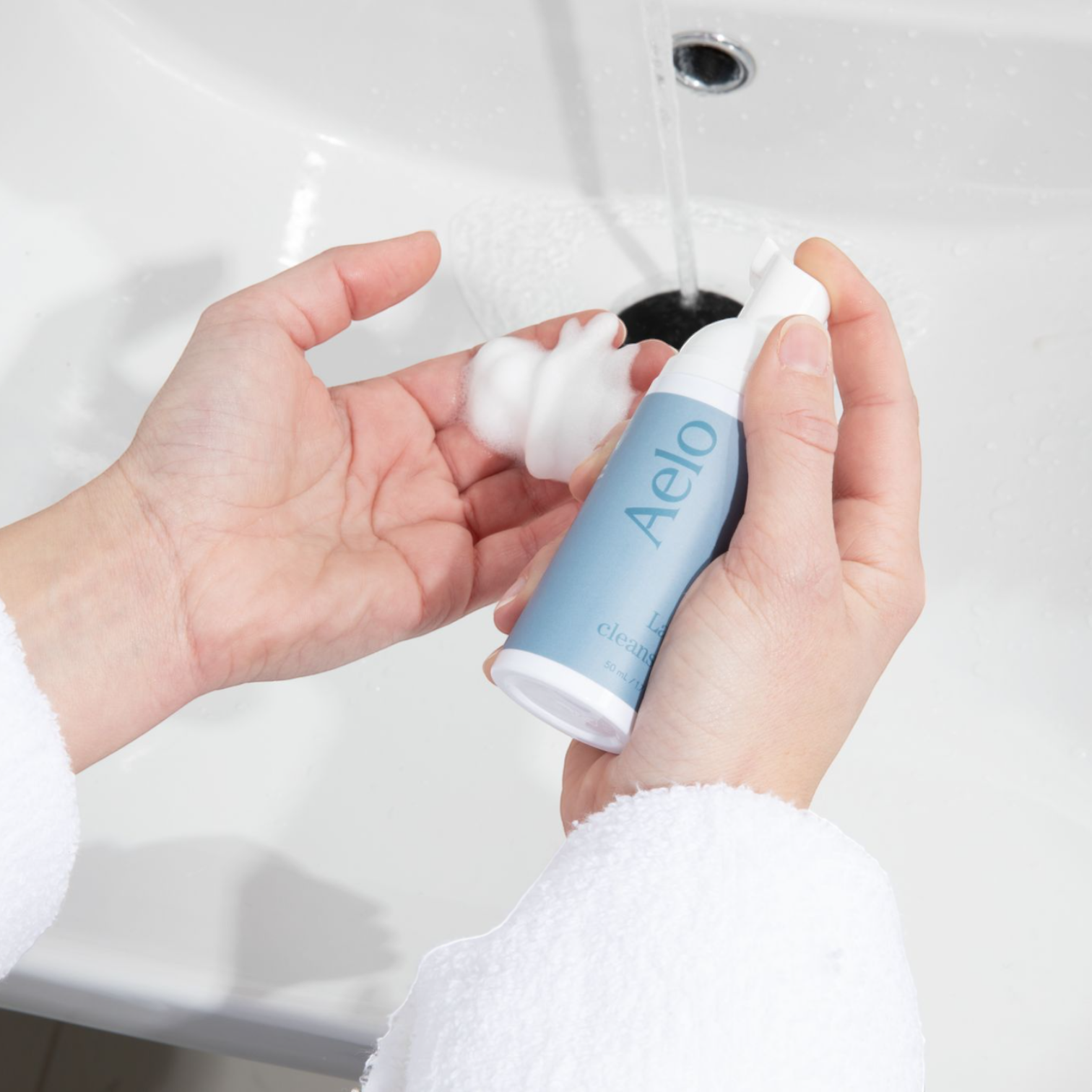 Aelo Eyelid and Eyelash Cleanser Being Used In The Bathroom Sink