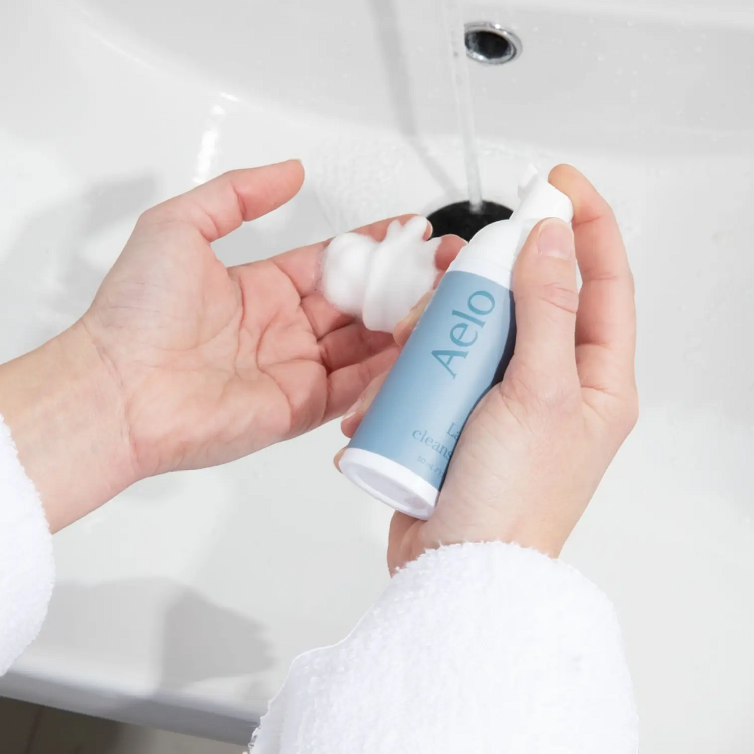 Aelo Eyelid and Eyelash Cleanser Being Used In The Bathroom Sink