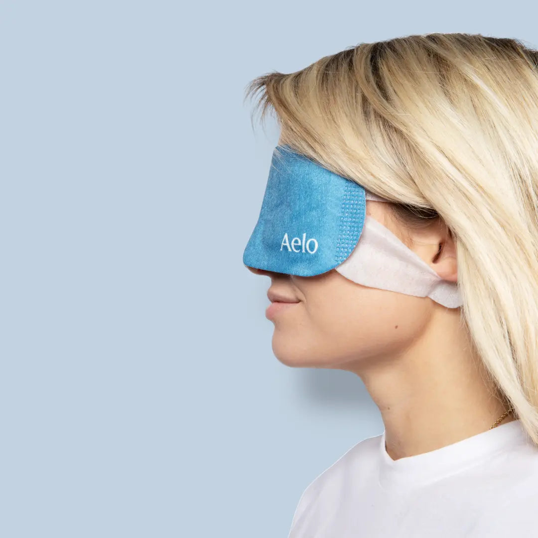 female model side profile wearing aelo self heating eye mask